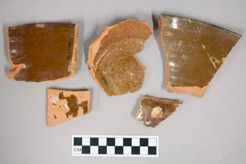 Large sherds of heavy, coarse ware; Brown glaze; 1 basal, 2 rim and 2 body sherd