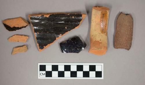 Miscellaneous coarse orange ware sherds; One jug handle, unglazed; Three brown g