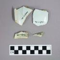 Undecorated tin glaze rim and body sherds.