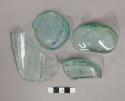 Pieces of clear blue green bottle glass; Elliptical and round bottoms; Plain she