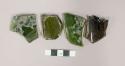 Sherds of at least 3 bottles; Probably wine. no dating possible. dark green an