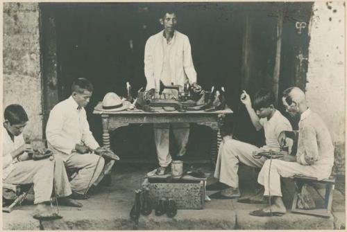 Men working in a shoe shop