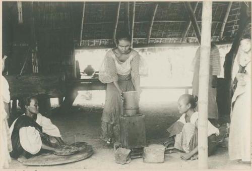 Women preparing to extract oil for cooking