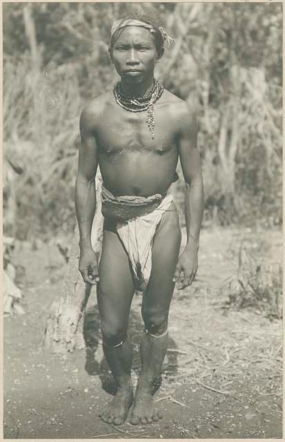 Mangyan man wearing traditional jewelry and hair style