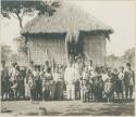 Group of Mangyans standing in front of hut