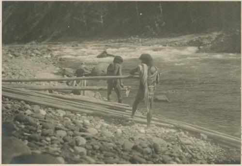 Kalinga men in Tooktook building bamboo rafts