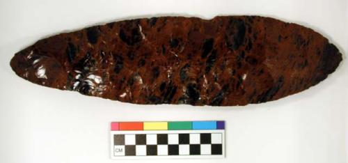 Chipped implement, red & black mottled obsidian