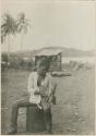 Boy striking fire with bamboo tool