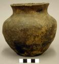 Ceramic vessel, flared neck, flat base, plain, micaceous clay.