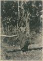 Woman from Bataan posed by stump