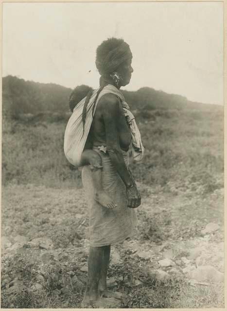 Woman carrying child on back