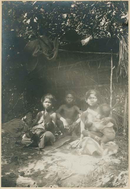 Woman, man, and baby in hut