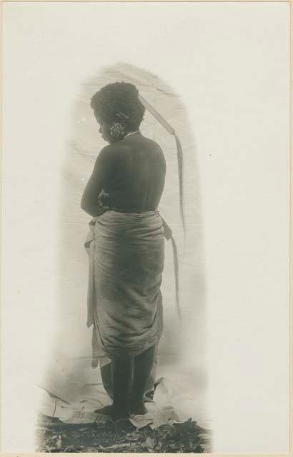 Back view of woman with cigar behind ear