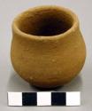 Ceramic miniature vessel, straight neck, round base, plain.