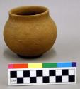 Ceramic vessel, complete, short straight neck, plain.