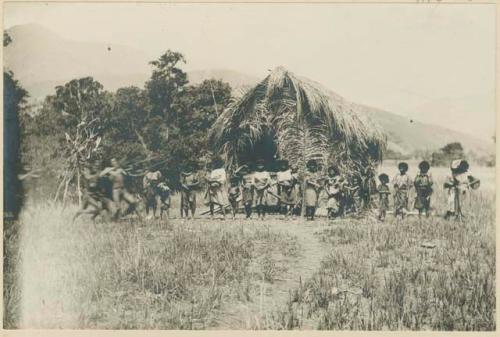 Upper class group in front of hut