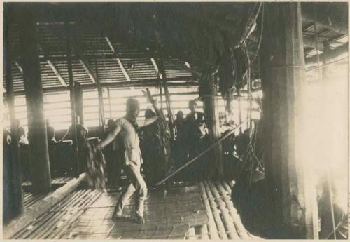 Subano priest dancing with leaves of anao in his hands