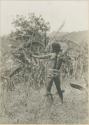 Young man posed shooting bow and arrow