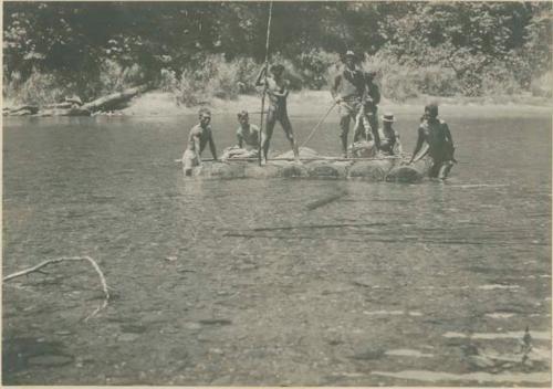 Mangyan and Tagalog folks leading Dr. Miller across river