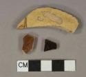 yellow, reddish brown, and black slip glazed earthenware vessel body fragments, buff paste