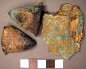 Metal ornament fragments, copper and gold, flat, conical, heavily corroded.