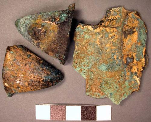 Metal ornament fragments, copper and gold, flat, conical, heavily corroded.