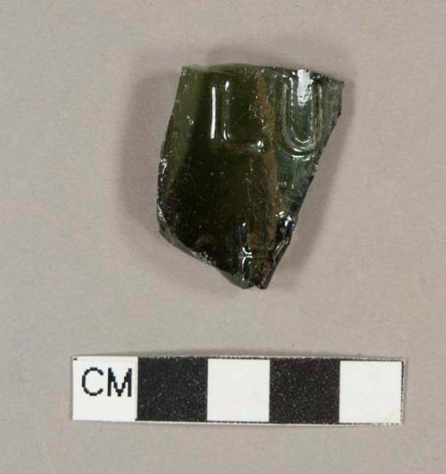 Olive green bottle glass fragment with embossed letters "LU" and "H"