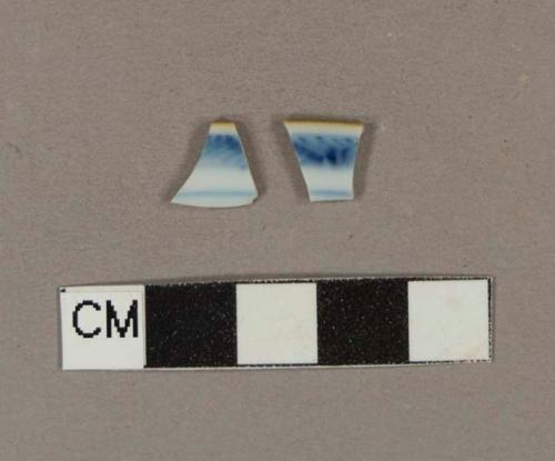 Blue hand painted porcelain rim sherds with brown glaze on top of the rim; two sherds crossmend