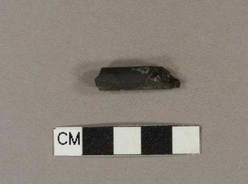 Black pipe stem fragment; appears burned and bore hole is completely filled in, making it unmeasurable - estimated to be at least 6/64" diameter