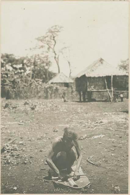 Woman ginning cotton