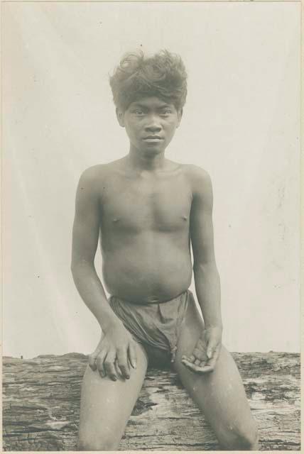 Mangyan man sitting on tree stump