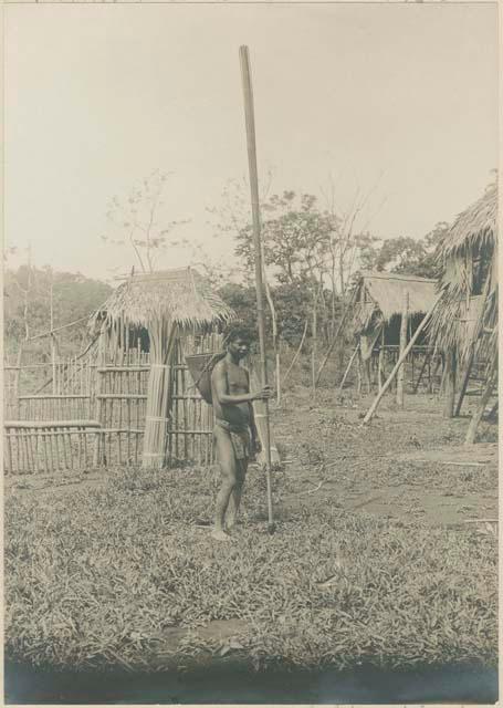Man with traditional Mangyan carrying basket and long bamboo pole