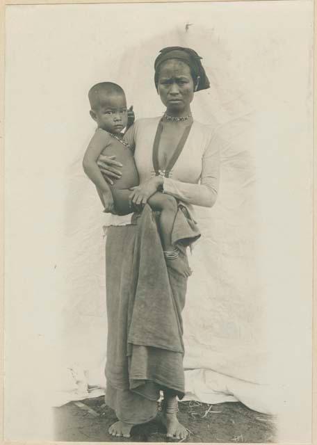 Mother and child with brass ankle bracelets