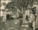 Group in western dress, man in beaded