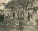 Group in western dress, man in beaded