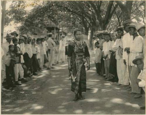 Group in western garments, woman in beaded