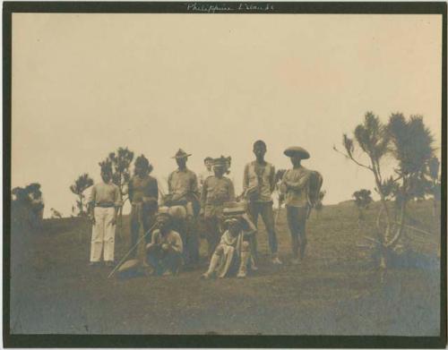 Men, various garments, grass field