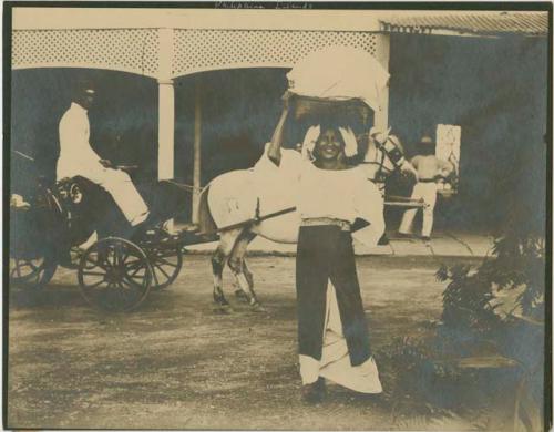 Woman with basket on her head, carriage