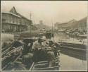 Boats, men transporting goods