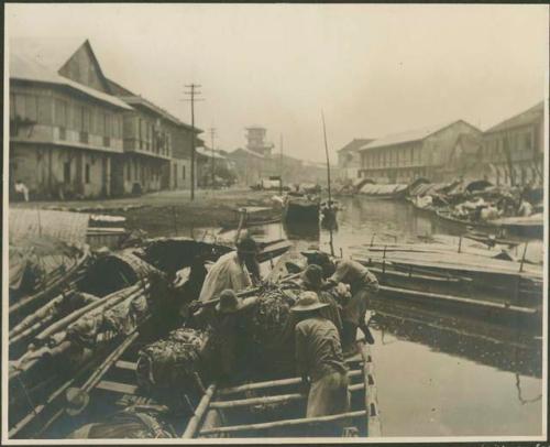 Boats, men transporting goods