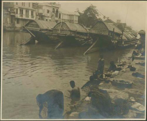 Group washing laundry in river