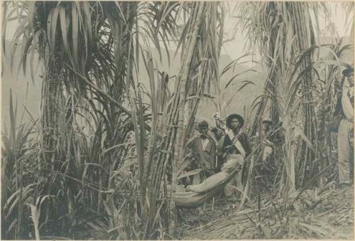 Major Crawford in hammock, soldiers and carriers behind