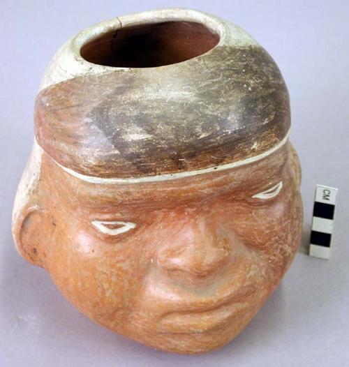 Vase, human head