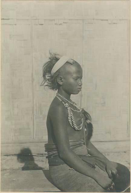 Young Batak woman, with bead and fur ornaments