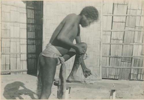 Batak man making fire