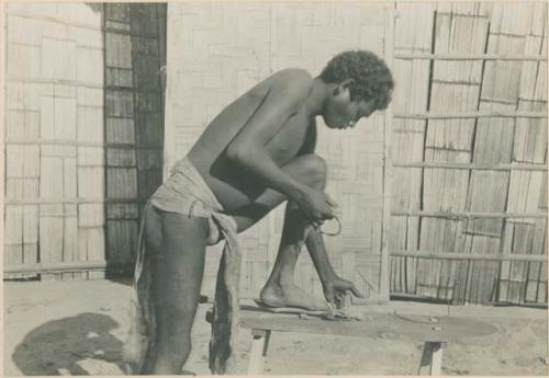 Batak man making fire