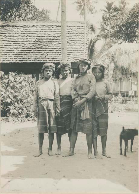 Four young Tingian women, and dog