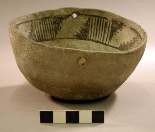 Gray clay bowl with band of black designs inside - two small holes on opposite s