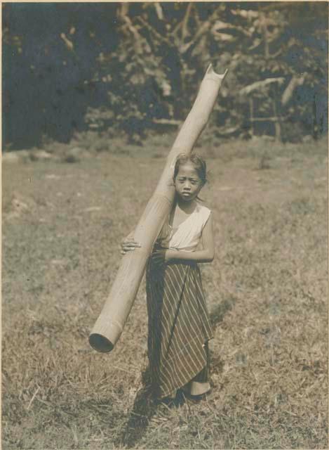 Visayan girl carrying bamboo full of water