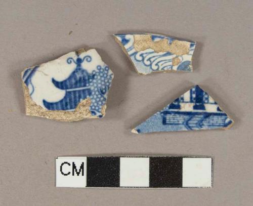 Blue on white transferprinted lead glazed earthenware vessel body and rim fragments, light buff paste